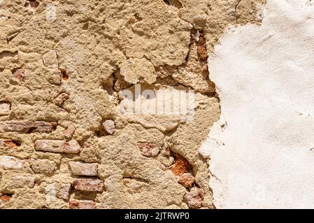 Old Wall Texture. Old brick wall made of bricks and plaster Stock Photo