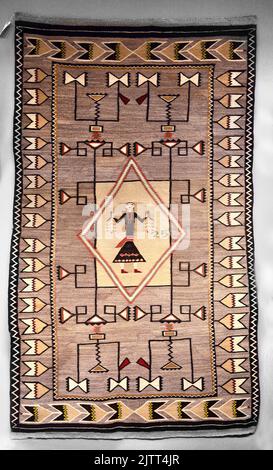 A vintage Navajo wool rug made by a Native Americana weaver for sale in Santa Fe, New Mexico. Stock Photo