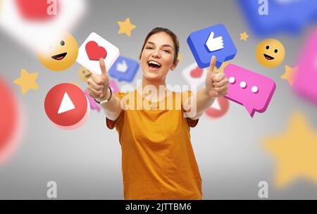 happy woman showing thumbs up over internet icons Stock Photo