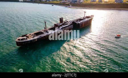 Drone photography of a rusty shipwreck at the Black Sea located next to Costinesti beach, in Romania. Aerial photography shot at a higher altitude. Stock Photo