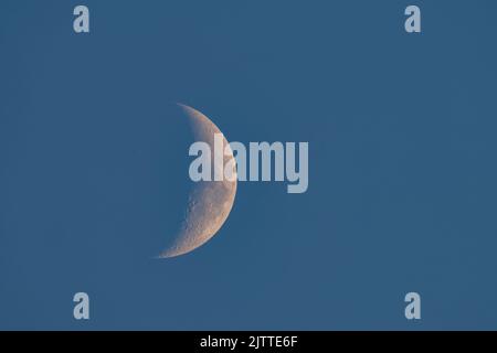 Waxing crescent moon in the evening sky. Stock Photo