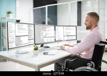 Computer Programmer Writing Program Code On Computer In Office Stock Photo