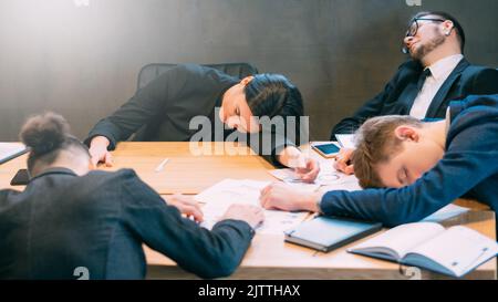 overtime work deadline exhausted professional team Stock Photo