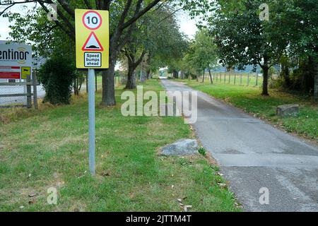 August 2022 - Speed limit sign and traffic calming humps in the access road to Cheddar reservoir on the Cheddar side access by the Rugby club. Stock Photo