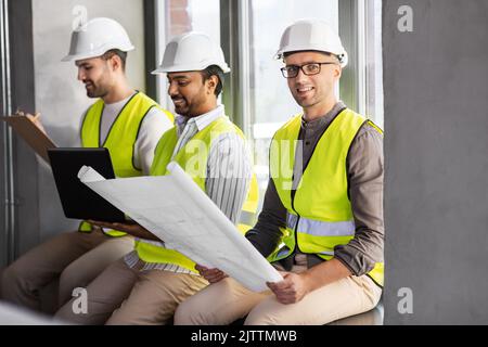 male architects in helmets working at office Stock Photo