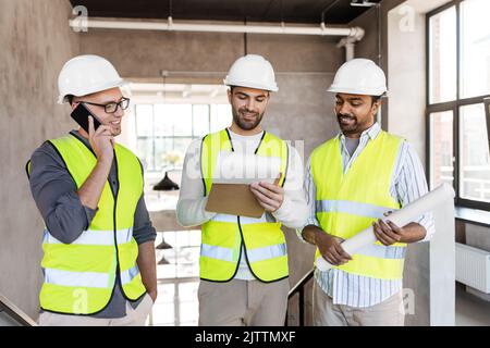 male architects in helmets working at office Stock Photo