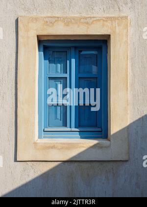 Old light blue wooden window closed with shutters Stock Photo