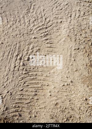 Beige textured wall with plaster applied with putty knife in irregular dashes and strokes. Vertical Stock Photo