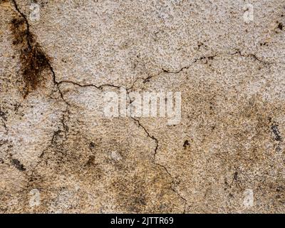 Close up of crack in old stone plastered wall Stock Photo