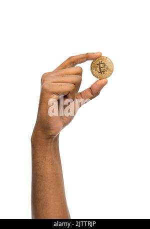 close up of hand with bitcoin over white Stock Photo