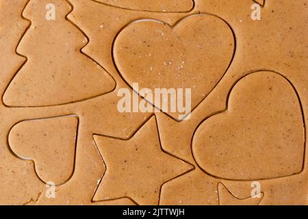 Making cookies in the shape of heart, Christmas tree, star from shortbread dough. Stock Photo