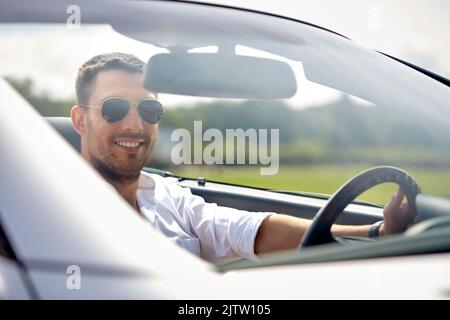 happy man in sunglasses driving convertible car Stock Photo