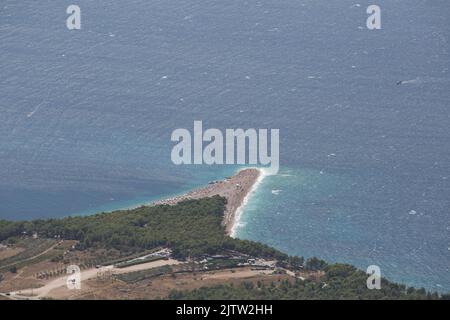 Aerial view of Zlatni Rat (Golden Horn) beach taken from Vidova Gora, Croatia's famous beach with turquoise waters and surrounding rugged landscape Stock Photo