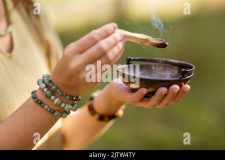 woman with palo santo performing magic ritual Stock Photo