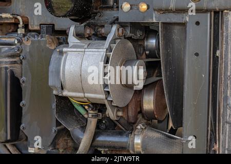 Alternator and serpentine belt on farm tractor. Agriculture and farming equipment repair, maintenance and service concept Stock Photo