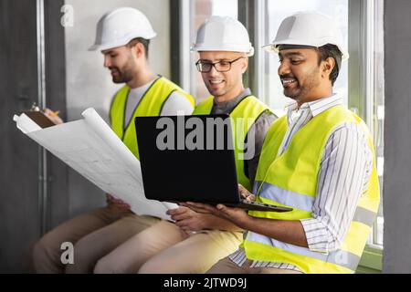 male architects in helmets working at office Stock Photo