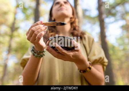 woman with palo santo performing magic ritual Stock Photo