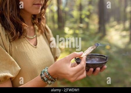 woman with palo santo performing magic ritual Stock Photo