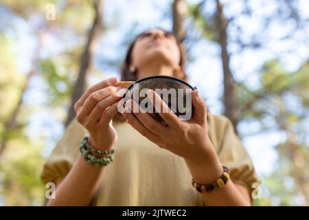 woman with palo santo performing magic ritual Stock Photo