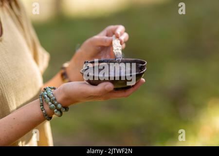 woman with palo santo performing magic ritual Stock Photo