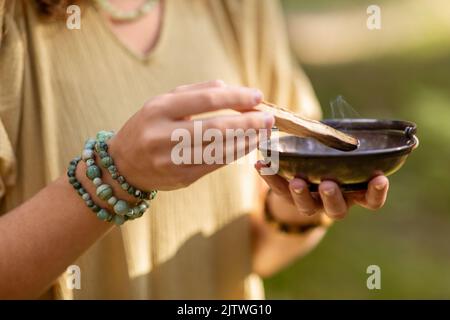 woman with palo santo performing magic ritual Stock Photo