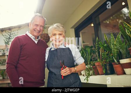 Were enjoying the free time retirement brings. Portrait of a loving senior couple garedening outside. Stock Photo