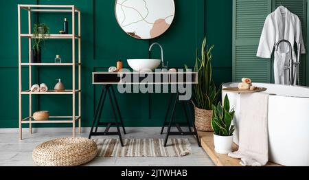 Interior of stylish bathroom with sink, mirror and shelving unit Stock Photo