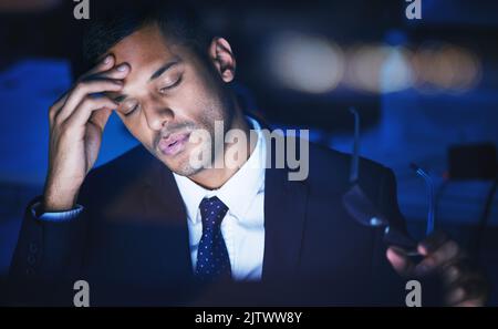 Night, stress and headache of a businessman working overtime or late in dark office for 404 report, IT coding or software deadline. Tired, frustrated Stock Photo