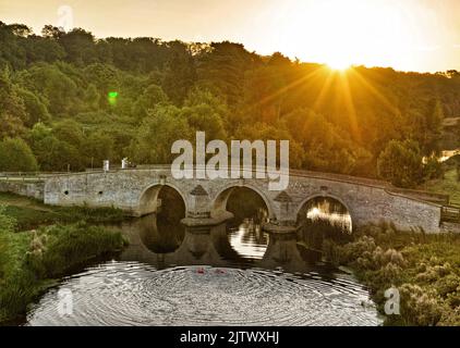 Peterborough, UK. 31st Aug, 2022. The sun begins to rise behind Milton Ferry Bridge as open water swimmers Karen Goodacre and Heather Yeoman head out for an early morning swim in the River Nene in Peterborough, Cambridgeshire, UK, on August 31, 2022 Credit: Paul Marriott/Alamy Live News Stock Photo