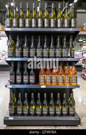 Bottles of wine on display on shelves in a supermarket. Photo: David Rowland / One-Image.com Stock Photo
