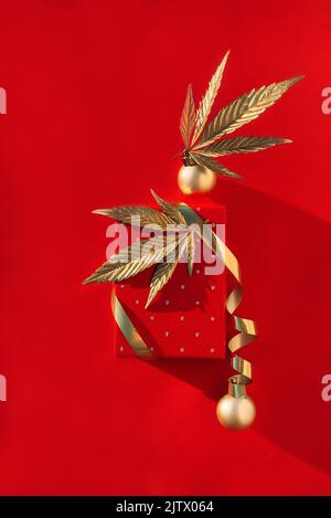 Golden Christmas balls with golden leaves of marijuana on red ...