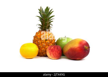Assortment of fresh healthy fruits including an pineapple, mango, apple and lemon isolated on a white background Stock Photo