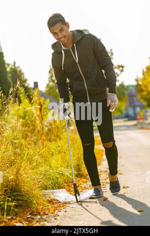 Smiling volunteer conserving environment from pollution and plastic Stock Photo