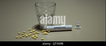 glass of water and anxiolytic pills. Remedy for those suffering from anxiety and panic attacks Stock Photo