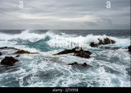 Stormy weather with big waves on rocky coast Stock Photo