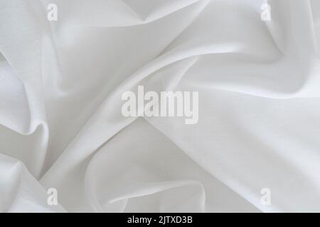 White drapery linen fabric background. Texture of the light surface of the fabric. High quality photo Stock Photo