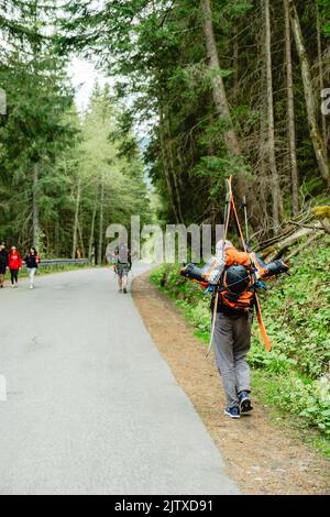 Tourists on the trail in the mountains Stock Photo