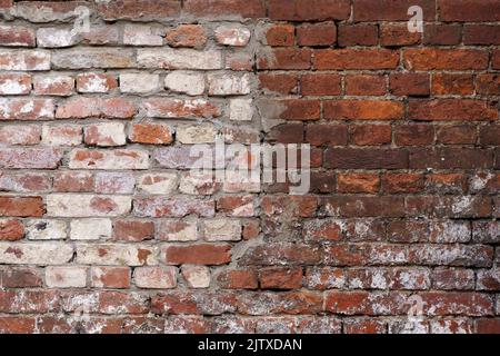Old brick wall. Brickwork from an old brick in a rustic style. The structure and pattern of the destroyed stone wall. Copy space. High quality photo Stock Photo