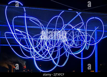 Spaghetti pattern of hanging beams of light with smoking chimneys show how polluting industries produce electricity and feed the digital progress Stock Photo