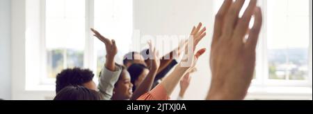 Banner background with happy audience raising their hands to ask speaker questions Stock Photo