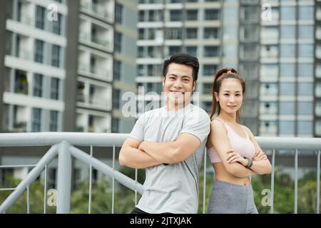 Happy fit man and woman smiling and looking at camera Stock Photo