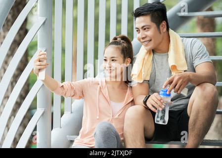 Pretty sporty woman talking selfie with her boyfriend Stock Photo
