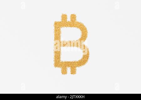 Bitcoin sign made of golden glitter against plain background Stock Photo