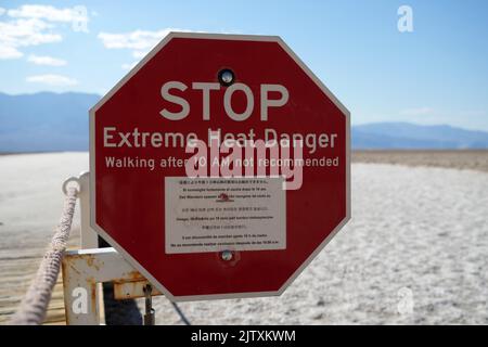 A stop sign warns of extreme heat danger in Badwater Basin, Thursday, Sept. 1, 2022, in Death Valley National Park, Death Valley National Park, Calif. Stock Photo