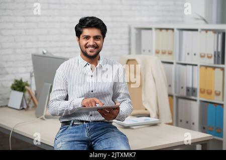 Indian It company manager using application on tablet computer Stock Photo