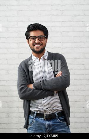 Portrait of confident handsome Indian man smiling and looking at camera Stock Photo