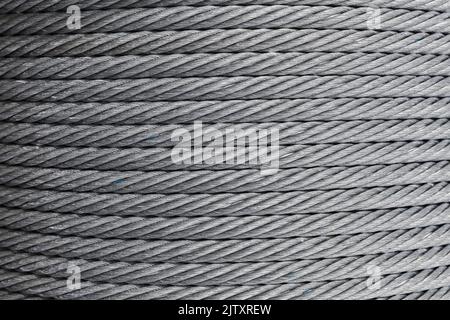 Steel rope is on a winch, abstract industrial background texture Stock Photo