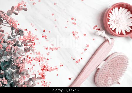 Toned spa background with herbs, flowers, sea salt, wooden brush scrub. Marble floor in salon. Healthcare backgrounds Stock Photo