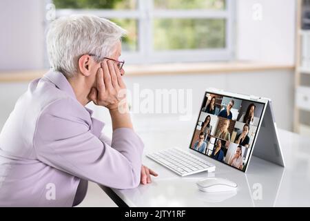 Bored Employee In Video Conference Training Meeting Stock Photo