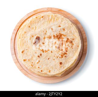 Traditional chapati cakes on a blackboard are isolated on a white background in close-up. Stock Photo
